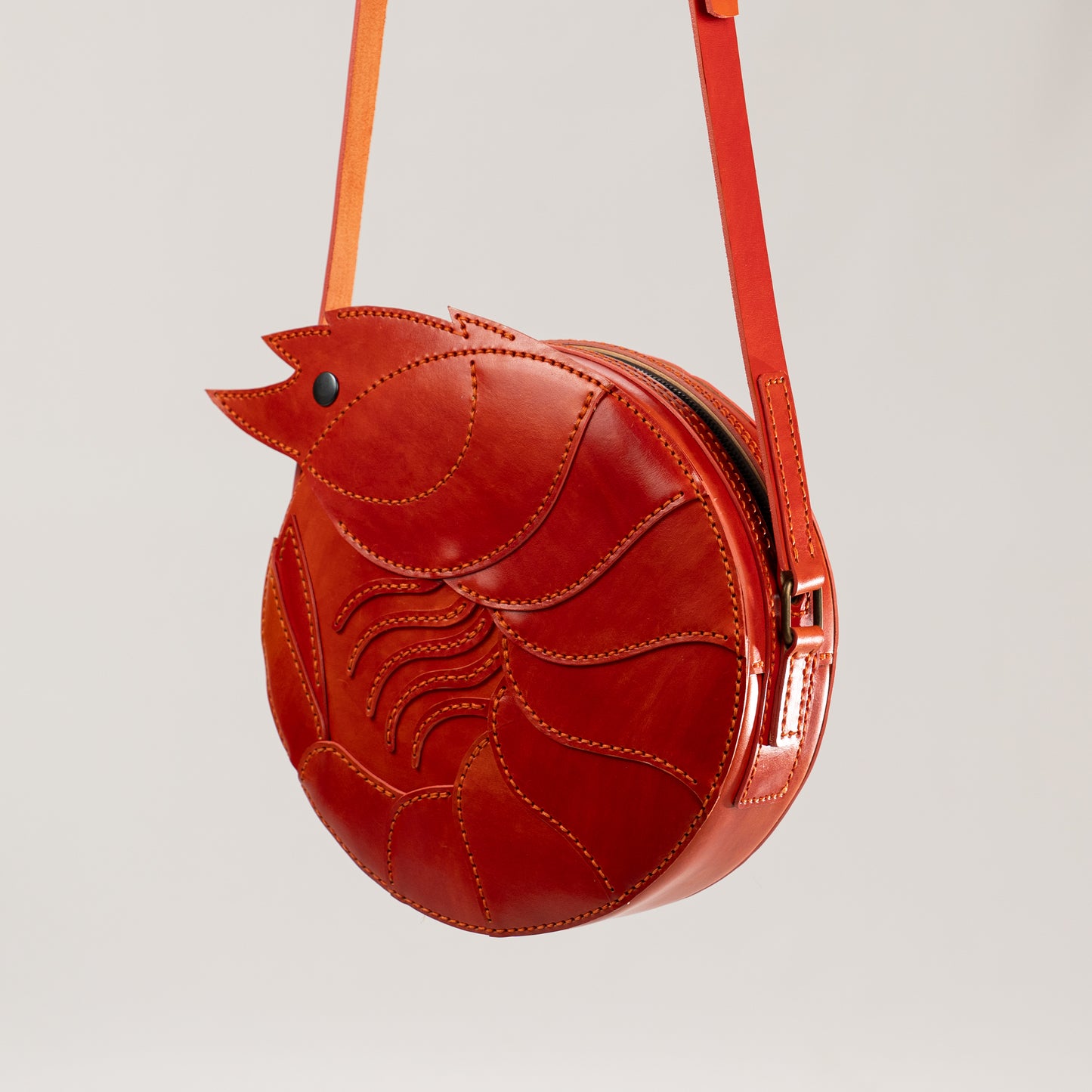 Limited-edition shrimp leather handbag with hand-dyed orange texture by ATOM LEATHER. Closed ith a zipper.