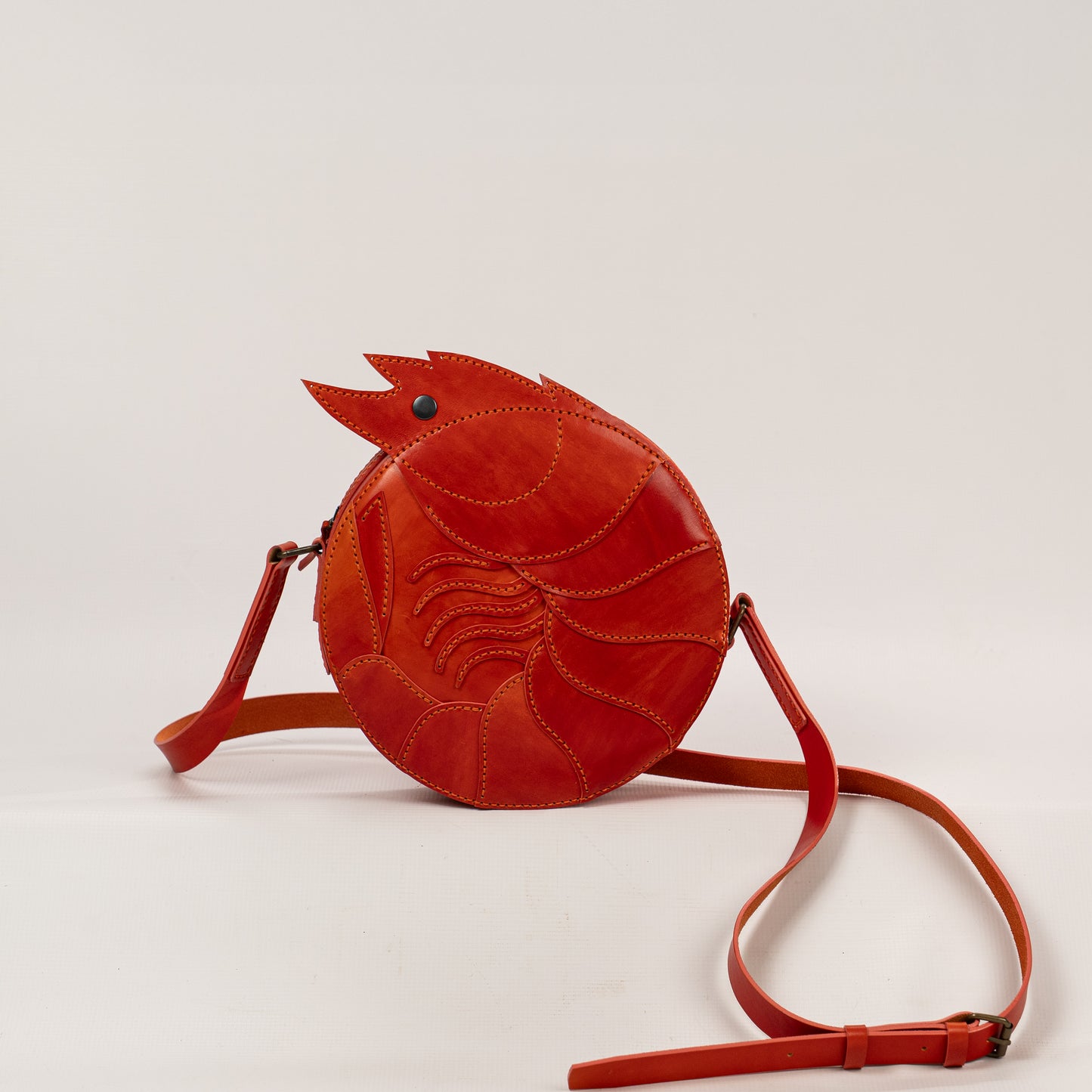 Limited-edition shrimp leather handbag with hand-dyed orange texture by ATOM LEATHER.