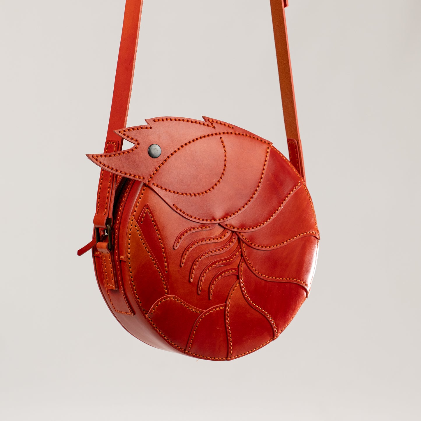 Limited-edition shrimp leather handbag with hand-dyed orange texture by ATOM LEATHER.