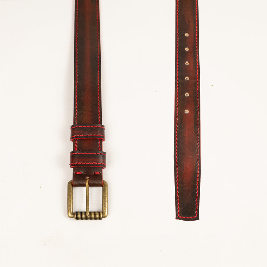 Artisan handcrafted red leather belt, entirely hand-stitched with antique brass hardware. Durable, stylish accessory perfect for everyday wear. Made by ATOM LEATHER.