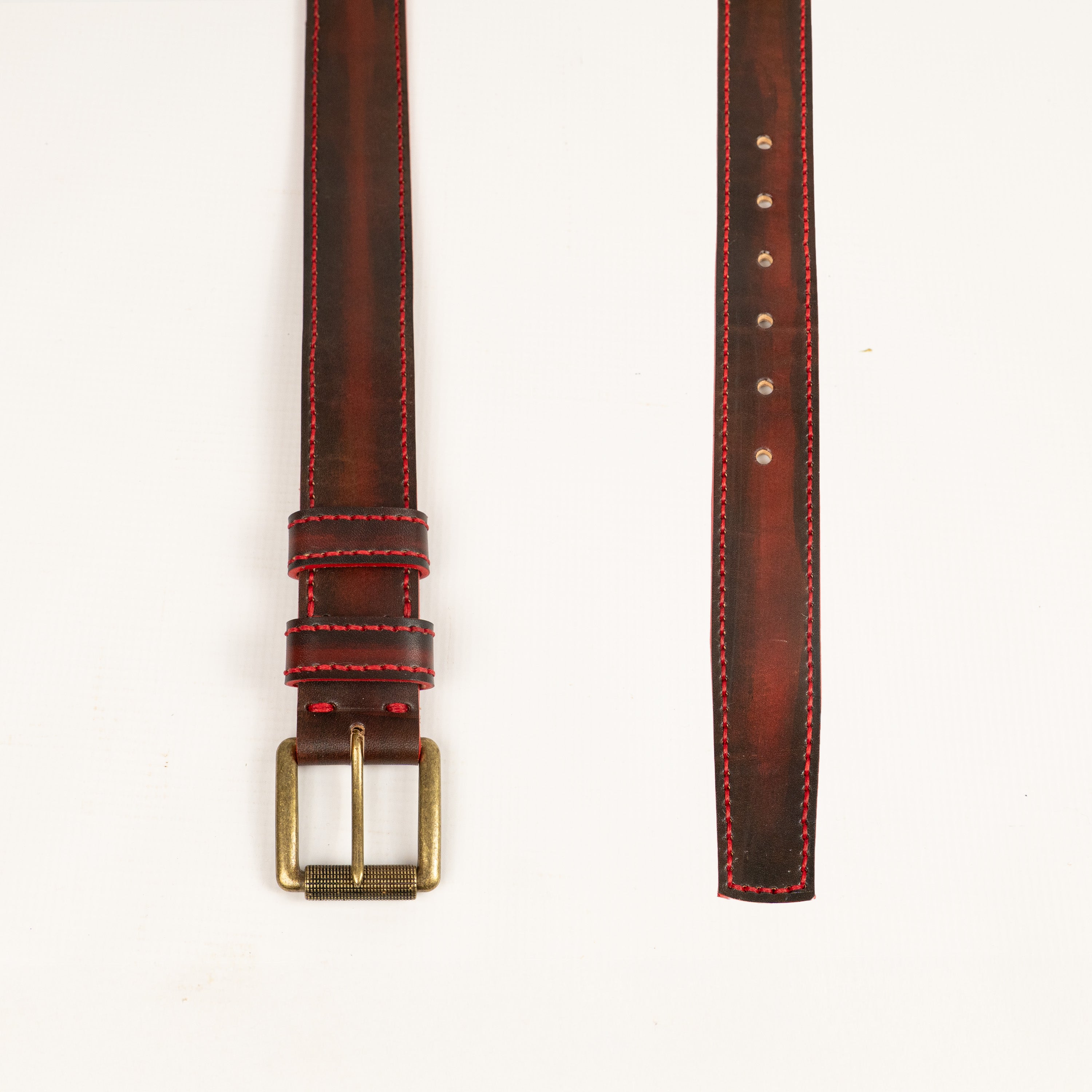 Artisan handcrafted red leather belt, entirely hand-stitched with antique brass hardware. Durable, stylish accessory perfect for everyday wear. Made by ATOM LEATHER.