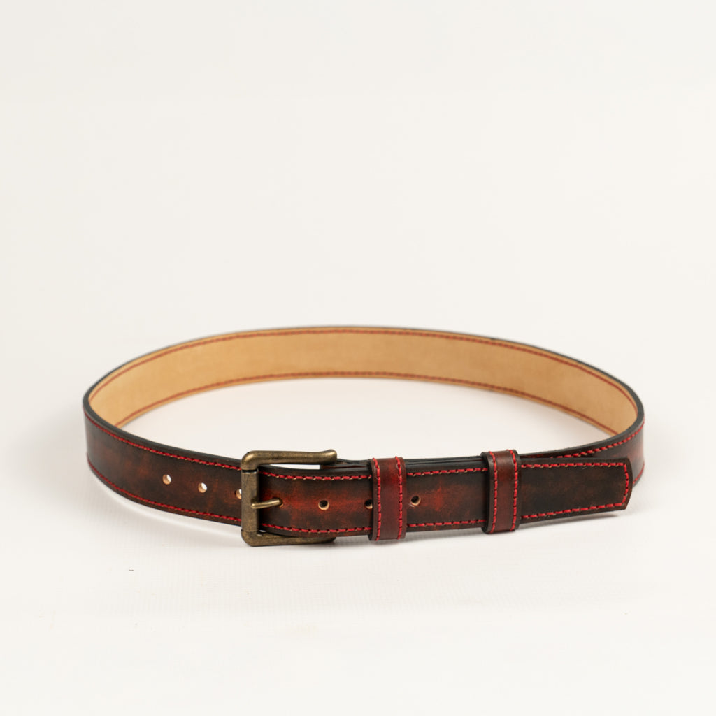 Artisan handcrafted red leather belt, entirely hand-stitched with antique brass hardware. Durable, stylish accessory perfect for everyday wear. Made by ATOM LEATHER.