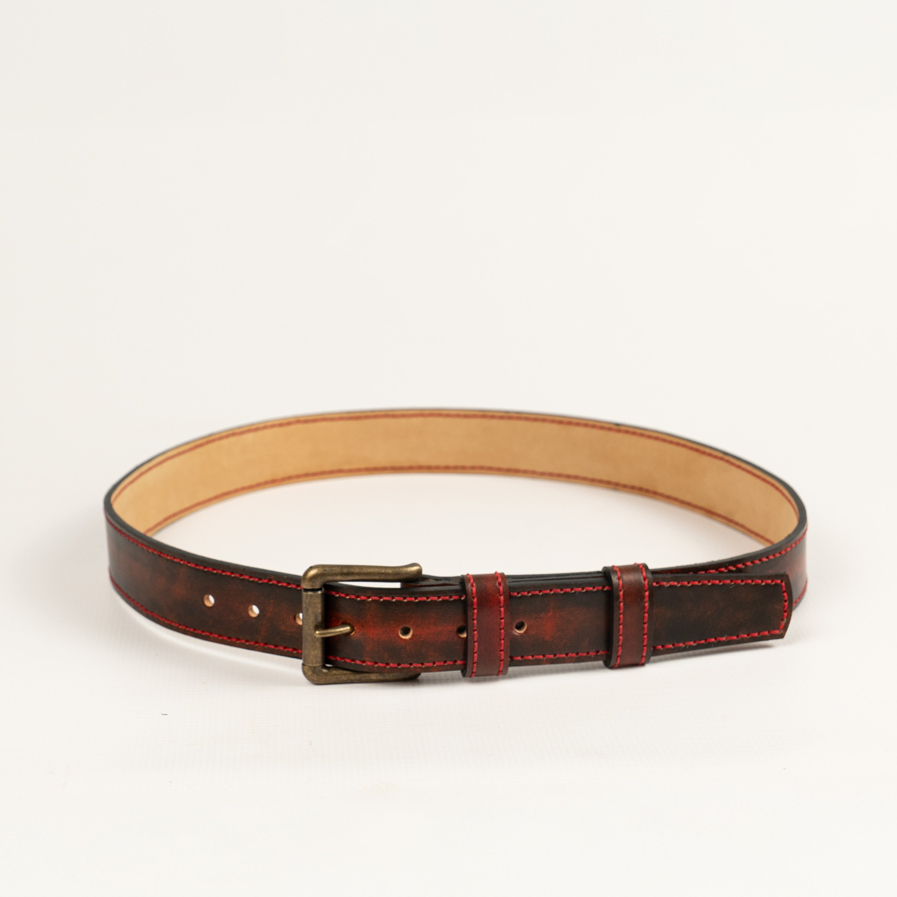 Artisan handcrafted red leather belt, entirely hand-stitched with antique brass hardware. Durable, stylish accessory perfect for everyday wear. Made by ATOM LEATHER.