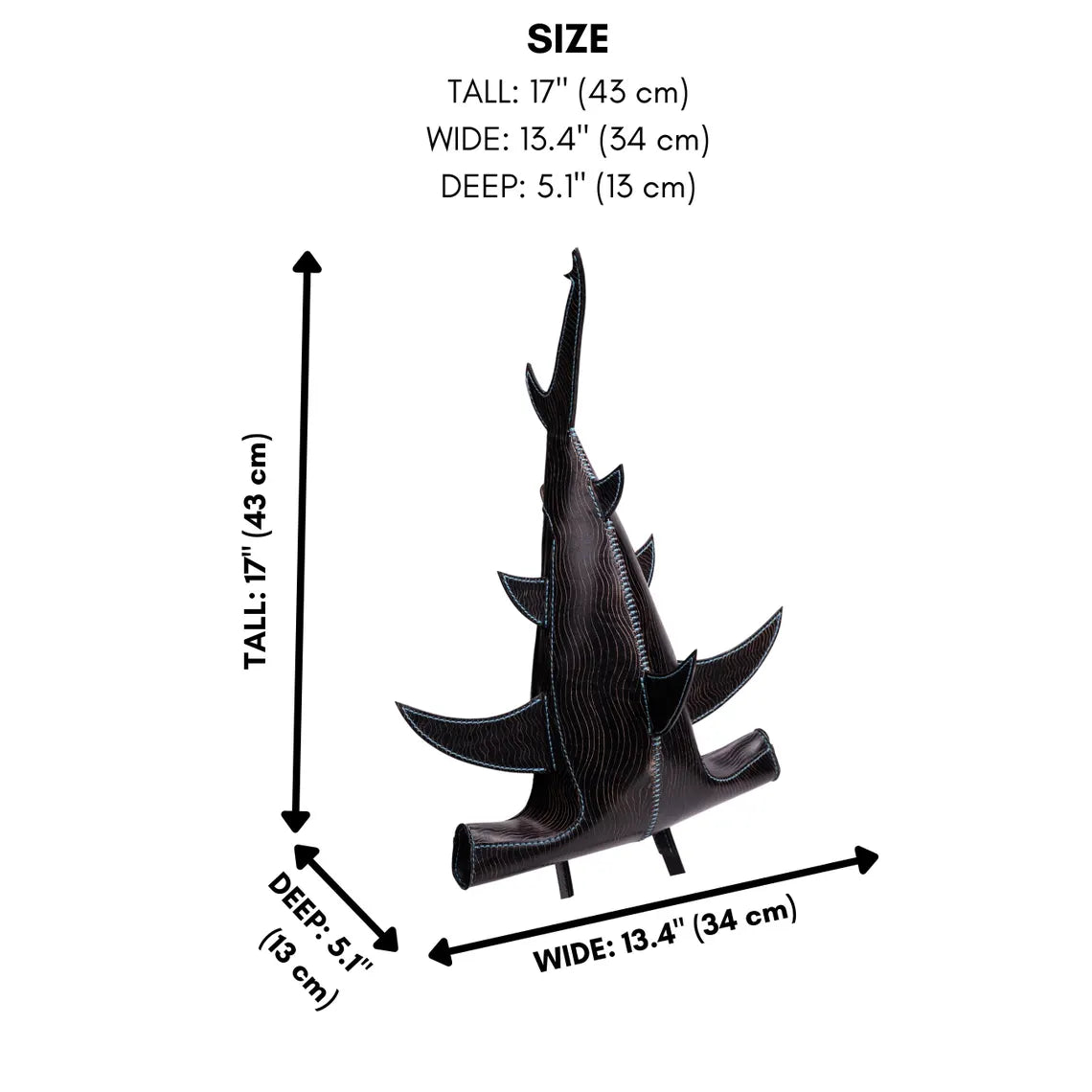 A black textured leather shark sculpture shown with dimension arrows and text indicating its size: tall 17 inches (43 cm), wide 13.4 inches (34 cm), and deep 5. Made by ATOM Leather.
