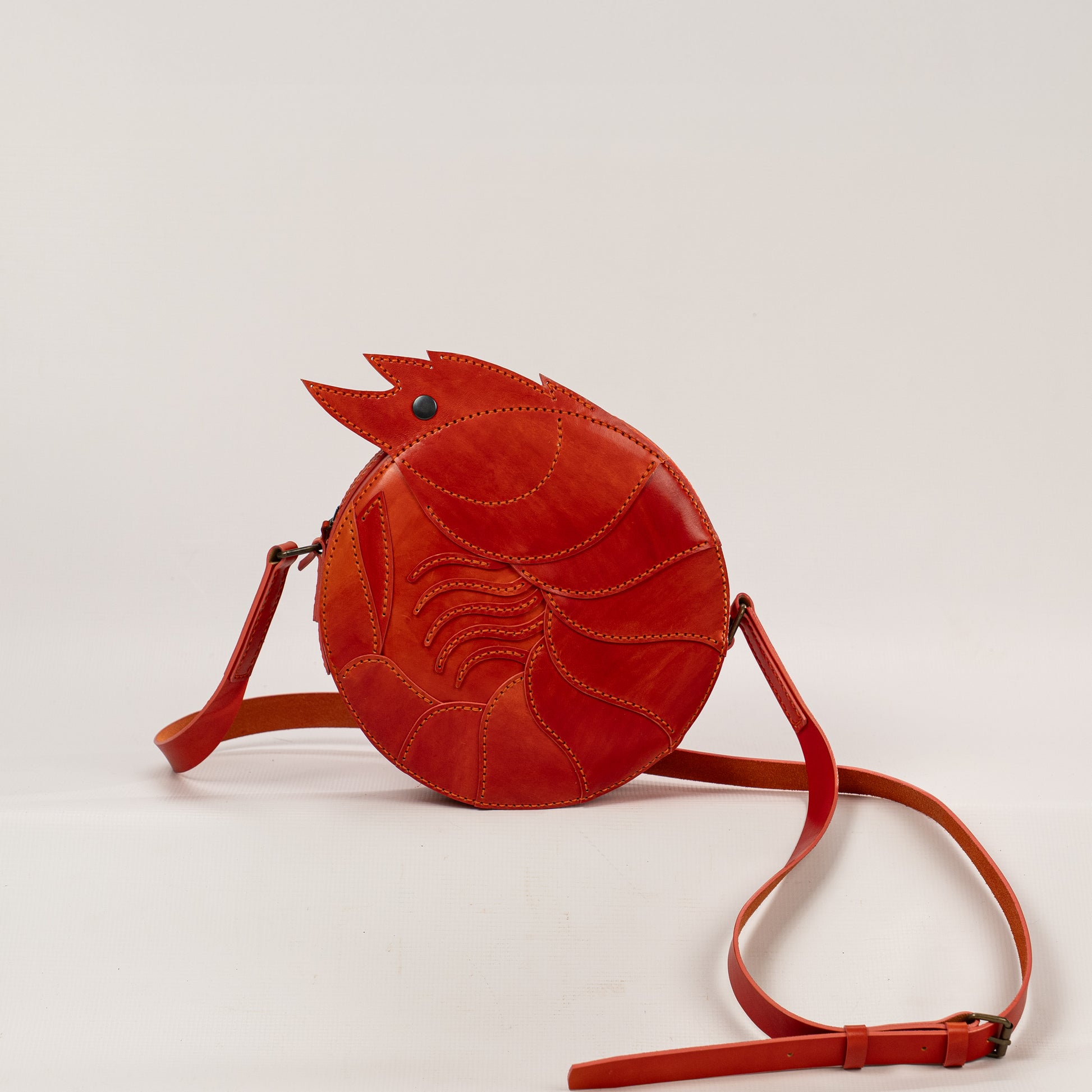 Limited-edition shrimp leather handbag with hand-dyed orange texture by ATOM LEATHER. 