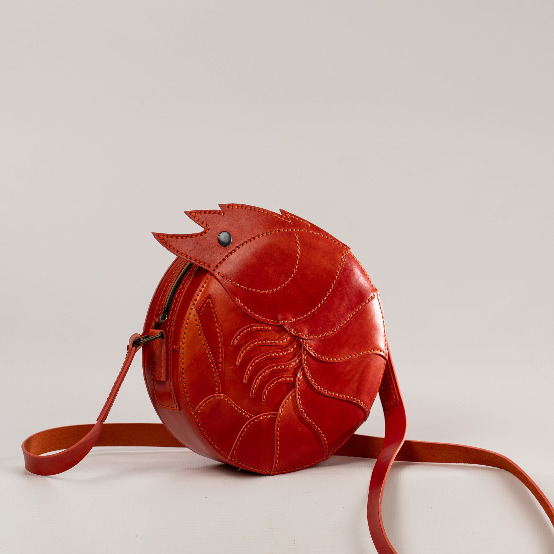 Limited-edition shrimp leather handbag with hand-dyed orange texture by ATOM LEATHER. 